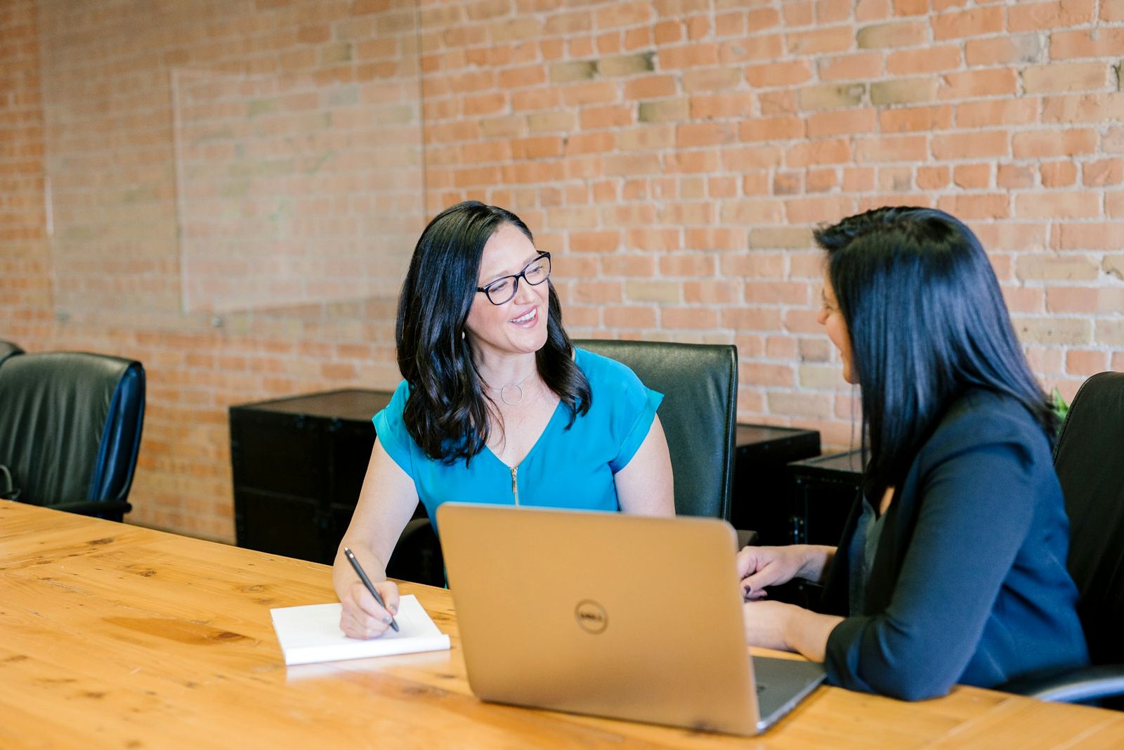 Two professionals in conversation at a table